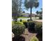 Serene neighborhood street view with manicured landscaping and palm trees, showcasing well-maintained homes at 8447 Sw 82Nd Loop, Ocala, FL 34481