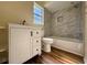 Bright bathroom with tiled shower, tub, vanity, and low consumption toilet at 8770 Sw 196Th Terrace Rd, Dunnellon, FL 34432