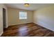 Bedroom with neutral paint, window, ceiling light and wood floors at 8770 Sw 196Th Terrace Rd, Dunnellon, FL 34432