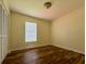Bedroom featuring neutral paint, window with blinds, ceiling light, and wood floors at 8770 Sw 196Th Terrace Rd, Dunnellon, FL 34432