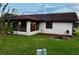Exterior view of a house showing the patio extension and well-kept backyard at 8770 Sw 196Th Terrace Rd, Dunnellon, FL 34432