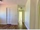 Neutral hallway featuring wood floors and closet at 8770 Sw 196Th Terrace Rd, Dunnellon, FL 34432