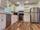 Modern kitchen with white cabinets, stainless steel appliances, and granite countertops at 8770 Sw 196Th Terrace Rd, Dunnellon, FL 34432