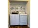 Laundry room with white washer and dryer at 8770 Sw 196Th Terrace Rd, Dunnellon, FL 34432