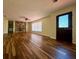 Open living room featuring wood-look floors and a stone fireplace, and a large window at 8770 Sw 196Th Terrace Rd, Dunnellon, FL 34432