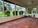 Spacious screened patio with brick flooring, offering views of the landscaped yard at 8770 Sw 196Th Terrace Rd, Dunnellon, FL 34432