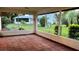 Sunroom or patio with tile floor and view of the backyard and a white home at 8770 Sw 196Th Terrace Rd, Dunnellon, FL 34432