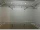 Walk-in closet with metal shelving system and neutral paint at 8770 Sw 196Th Terrace Rd, Dunnellon, FL 34432