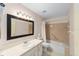 Bathroom featuring a shower/tub, vanity with large mirror, and ceramic tile flooring at 8885 Sw 90Th Ave, Ocala, FL 34481