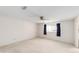 Bedroom features neutral carpet, a ceiling fan, and a window providing natural light at 8885 Sw 90Th Ave, Ocala, FL 34481