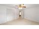 Bedroom featuring neutral carpet, a ceiling fan, and closet at 8885 Sw 90Th Ave, Ocala, FL 34481