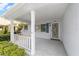Inviting covered porch with white railing, providing a cozy outdoor seating area at 8885 Sw 90Th Ave, Ocala, FL 34481