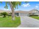 Charming single-story home with a two-car garage, covered porch, and a well-manicured lawn at 8885 Sw 90Th Ave, Ocala, FL 34481