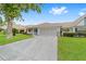 Lovely single-story home with a two-car garage and covered front porch set on a green lawn at 8885 Sw 90Th Ave, Ocala, FL 34481