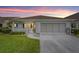 Charming single-story home featuring a covered porch, well-manicured lawn, and attached garage at 8885 Sw 90Th Ave, Ocala, FL 34481