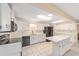 White cabinets, tile flooring, and black appliances in the well-lit kitchen at 8885 Sw 90Th Ave, Ocala, FL 34481