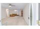 Spacious living room featuring neutral carpeting, a ceiling fan, and ample natural light at 8885 Sw 90Th Ave, Ocala, FL 34481