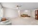 Bright living room with large windows, a ceiling fan, and cozy seating arrangement at 8885 Sw 90Th Ave, Ocala, FL 34481