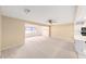 Bright and spacious living room with a large window and kitchen access at 8885 Sw 90Th Ave, Ocala, FL 34481