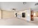 Open floor plan with living and kitchen areas, featuring white cabinets and carpet flooring at 8885 Sw 90Th Ave, Ocala, FL 34481