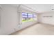 Bright living room with large windows, carpet, and a view of the outdoors at 8885 Sw 90Th Ave, Ocala, FL 34481