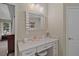 Bright bathroom vanity area with ample storage and a decorative mirror at 9175 Se 7Th Avenue Rd, Ocala, FL 34480