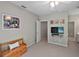 Spacious bedroom featuring a TV, seating area and doorway leading to a bathroom at 9175 Se 7Th Avenue Rd, Ocala, FL 34480