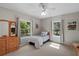 Bright bedroom with two windows and ceiling fan with a cozy bed and dresser at 9175 Se 7Th Avenue Rd, Ocala, FL 34480