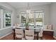 Bright dining room with pool view, featuring hardwood floors and modern lighting at 9175 Se 7Th Avenue Rd, Ocala, FL 34480