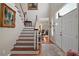 Bright foyer featuring a staircase, hardwood floors, and an inviting entryway at 9175 Se 7Th Avenue Rd, Ocala, FL 34480