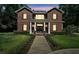 This charming all brick two-story home boasts stately columns, a manicured lawn, and a walkway to the front door at 9175 Se 7Th Avenue Rd, Ocala, FL 34480