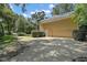 Spacious three-car garage with ample driveway space and mature landscaping at 9175 Se 7Th Avenue Rd, Ocala, FL 34480