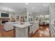 Open-concept kitchen with a central island, seating, and modern stainless steel appliances, great for entertaining at 9175 Se 7Th Avenue Rd, Ocala, FL 34480