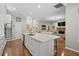 Bright, open kitchen with a large island and view to the living room's brick fireplace at 9175 Se 7Th Avenue Rd, Ocala, FL 34480