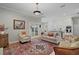 Inviting living room with an adjacent white kitchen, hardwood floors, and plenty of natural light at 9175 Se 7Th Avenue Rd, Ocala, FL 34480