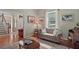 Comfortable living room featuring hardwood floors and a tufted couch filled with natural light from a large window at 9175 Se 7Th Avenue Rd, Ocala, FL 34480
