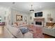 Spacious living room with a brick fireplace, neutral walls, and hardwood floors, creating a warm and inviting atmosphere at 9175 Se 7Th Avenue Rd, Ocala, FL 34480