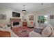 Inviting living room with a brick fireplace, plush seating, and access to outdoor patio at 9175 Se 7Th Avenue Rd, Ocala, FL 34480