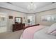 Charming main bedroom with view to the ensuite bath, and a decorative dresser at 9175 Se 7Th Avenue Rd, Ocala, FL 34480