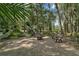 Enjoy the natural wooded surroundings from this brick paver patio with fire pit and comfortable chairs for relaxing at 9175 Se 7Th Avenue Rd, Ocala, FL 34480