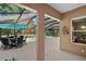 Covered patio showcasing a pool and outdoor dining area, seamlessly blending indoor/outdoor living at 9175 Se 7Th Avenue Rd, Ocala, FL 34480