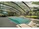 Private screened-in pool and patio with a waterfall, perfect for relaxing and entertaining at 9175 Se 7Th Avenue Rd, Ocala, FL 34480