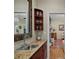 Convenient wet bar with granite countertop, stainless steel sink, and decorative shelving for glassware at 9175 Se 7Th Avenue Rd, Ocala, FL 34480