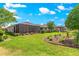 Lush backyard featuring a screened lanai, beautiful landscaping, and a serene setting at 9203 Sw 97Th Cir, Ocala, FL 34481