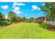 Large, meticulously maintained backyard with mature trees and vibrant greenery at 9203 Sw 97Th Cir, Ocala, FL 34481