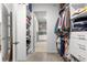 Walk-in closet view featuring shelving, door, and laundry area at 9203 Sw 97Th Cir, Ocala, FL 34481