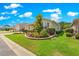 Landscaped front yard with mature trees, shrubs, and retaining wall, offering great curb appeal at 9203 Sw 97Th Cir, Ocala, FL 34481
