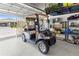 Garage interior featuring a golf cart and storage shelving at 9203 Sw 97Th Cir, Ocala, FL 34481