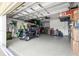 Garage view with golf cart, overhead storage, and epoxy flooring at 9203 Sw 97Th Cir, Ocala, FL 34481