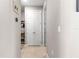 Hallway view featuring double doors, shelving, and neutral decor at 9203 Sw 97Th Cir, Ocala, FL 34481